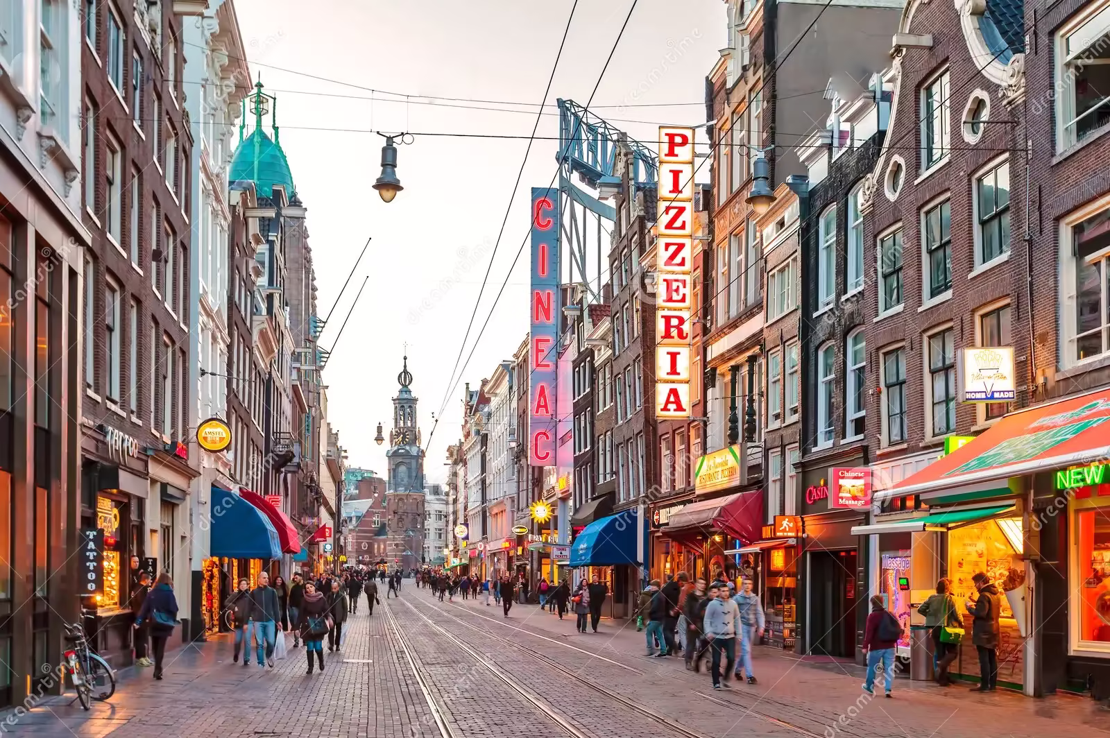 An example of a street: a roughly 8-12 metre-wide pedestrianised street, with tram lines going down the centre, a variety of covered shops located at street-level and residential homes above them rising to 4 stories in total, which is roughly the same height as the width of the street